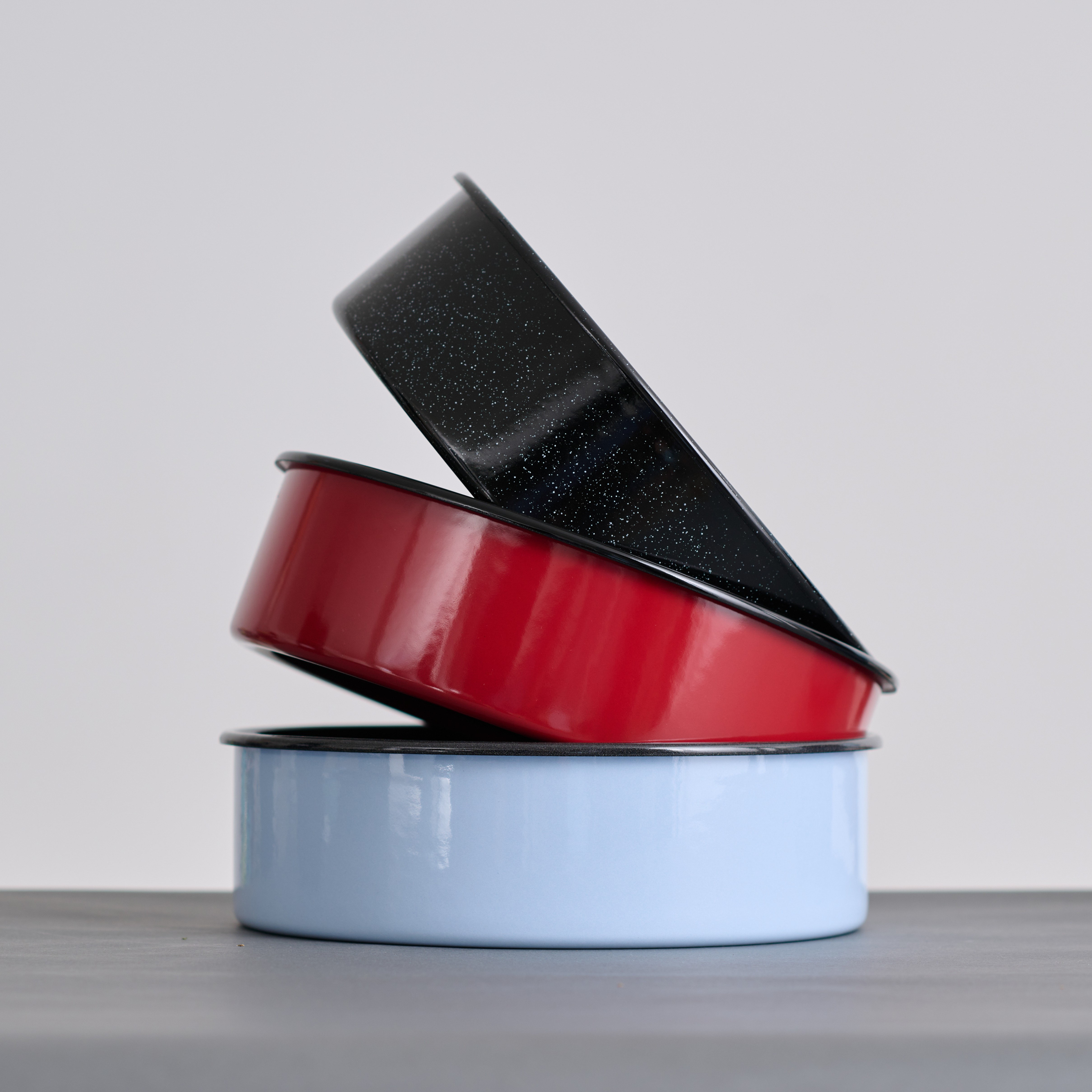 farbige Emaille Tortenformen in rot, schwarz und blau